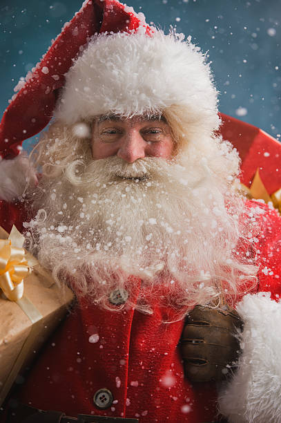 istock Claus outdoors in snowfall carrying gifts 491057854