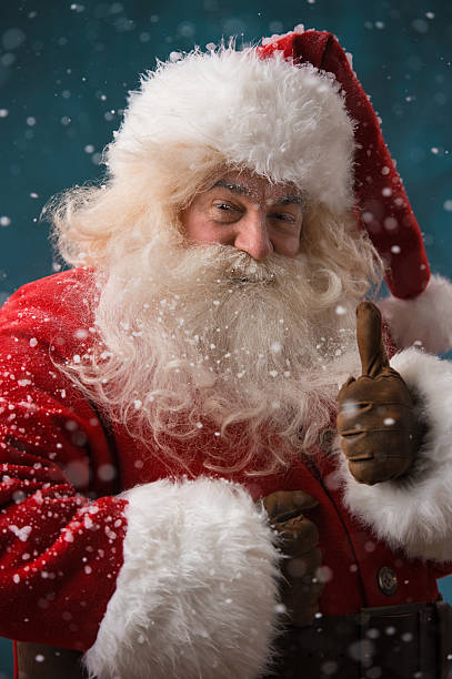 istock Santa Claus standing outdoors showing thumb up 491058076