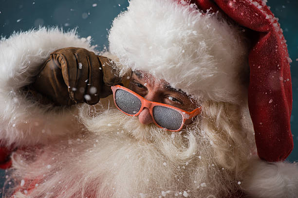 Santa Claus wearing sunglasses dancing outdoors at North Pole stock photo