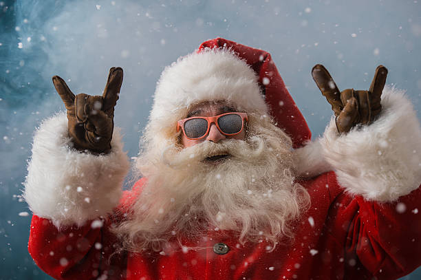 Santa Claus wearing sunglasses dancing outdoors at North Pole stock photo
