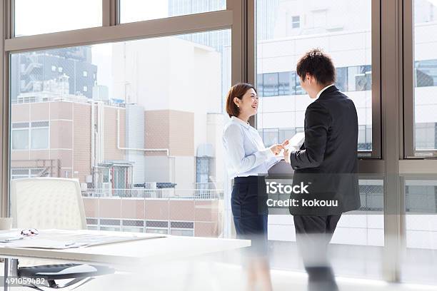 Businesswoman To Show The Tablet To The Man At Window Stock Photo - Download Image Now