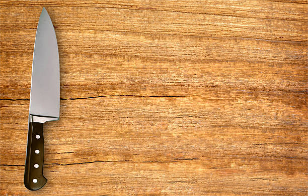 istock metal knife on cutting board isolated on white 491060072