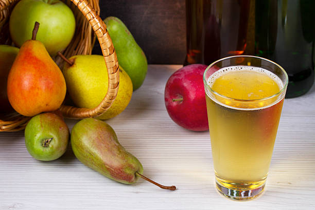 istock Apple and pear cider glass and bottles with fruits 491060744