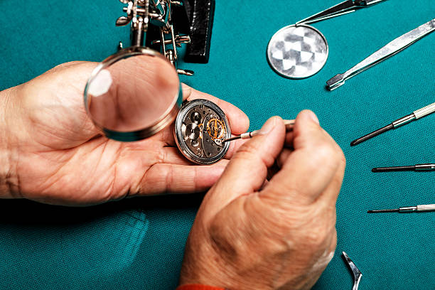 Repairing old pocket watch Pocket watch being repaired by senior watch maker, close-up. broken pocket watch stock pictures, royalty-free photos & images