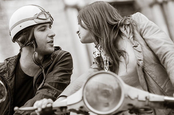 istock Guy and Girs Kissing on a Motor Scooter 491062919