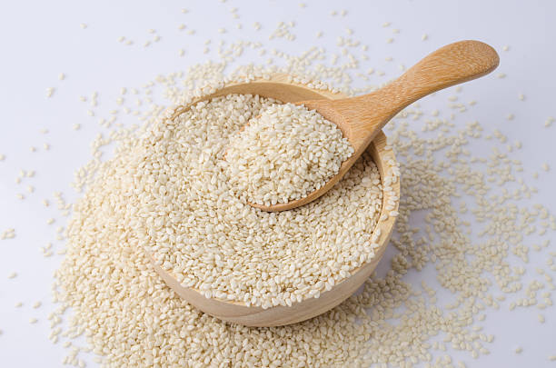 istock sesame seeds with wooden spoon 491062954