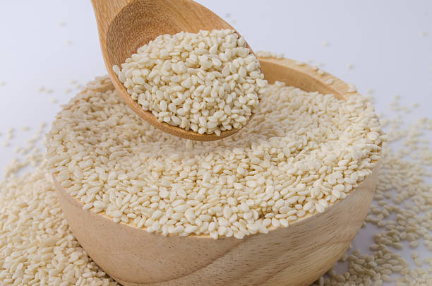 istock sesame seeds with wooden spoon 491063042
