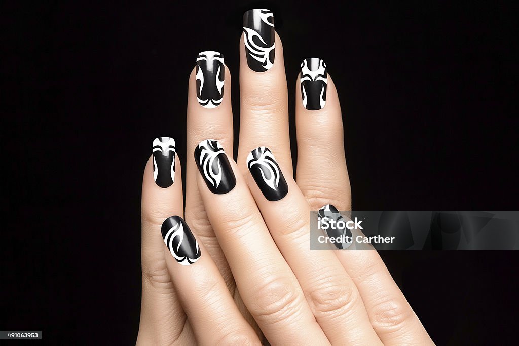 Art Nail Tattoo Closeup of woman hands with art nail design. Fashion print nail stickers. Manicure and Nail tattoo Acrylic Painting Stock Photo