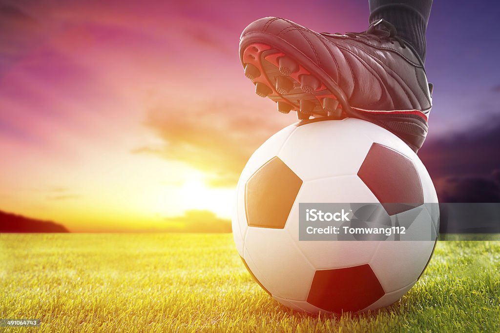 Football or soccer ball at the kickoff of a Football or soccer ball at the kickoff of a game with sunset Kick Off Stock Photo