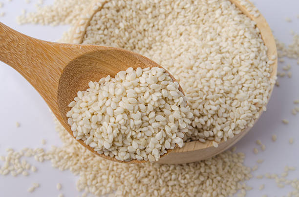 istock sesame seeds with wooden spoon 491067934