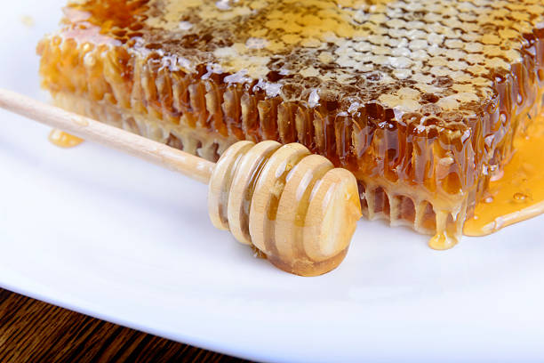 istock stick for honey near the honeycomb 491069006
