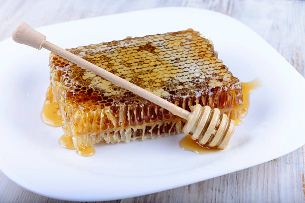 istock stick for honey near the honeycomb 491069436