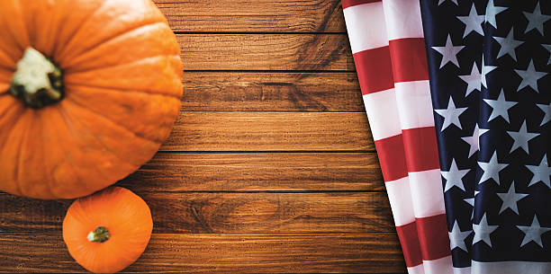 istock halloween pumpkin on rustic wood with usa flag 491069730