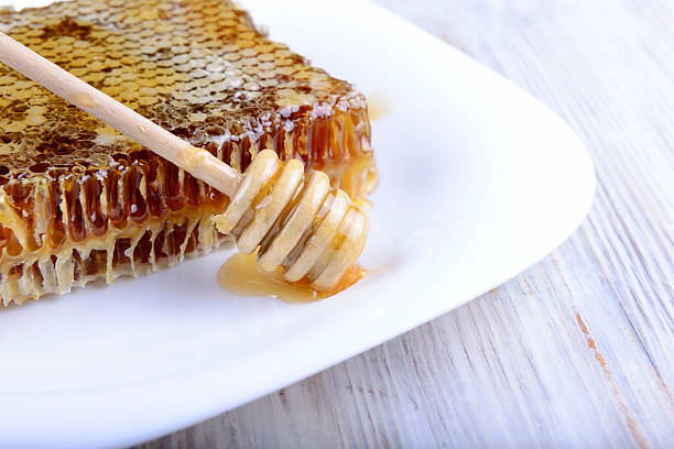 istock stick for honey near the honeycomb 491069906