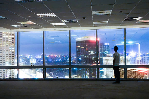 istock Man looking at cityscape from office window 491070006