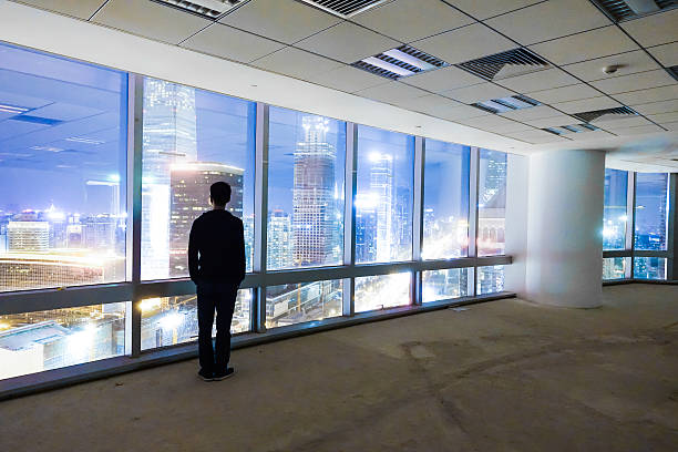 istock Businessman looking at cityscape at night 491070294