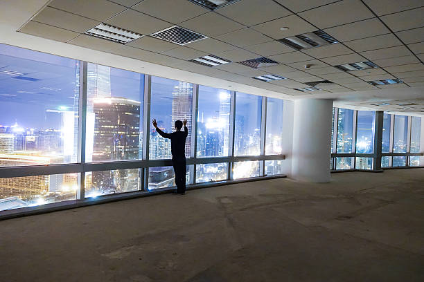 istock Businessman looking at cityscape at night 491070370