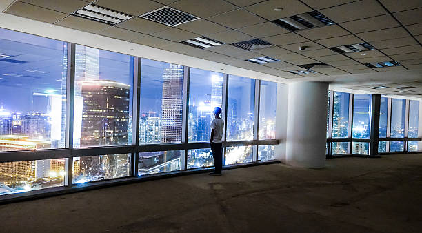 istock Businessman looking at cityscape at night 491070450