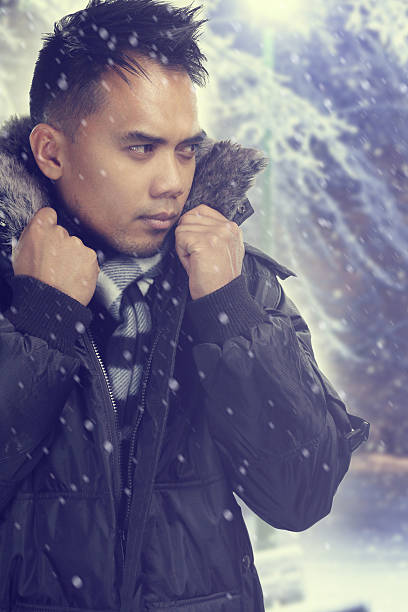 istock young man during a snowy night 491071260