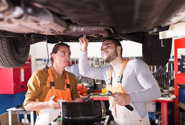 istock Mechanics repairing car of client 491072106