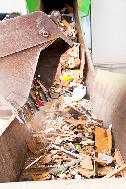 istock Excavator fills trash on a conveyor belt 491072436