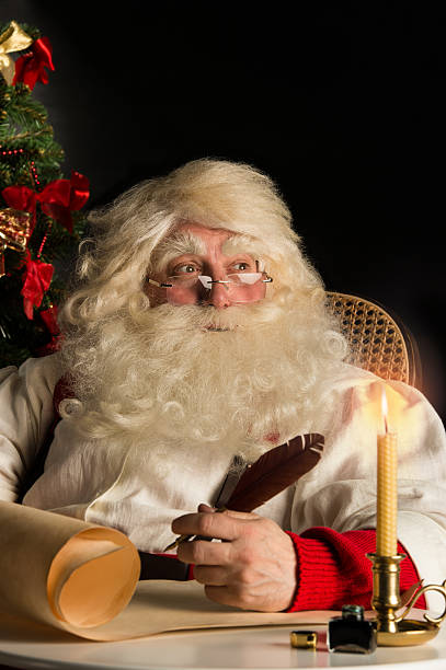 istock Santa Claus sitting at home and writing a letter 491073148