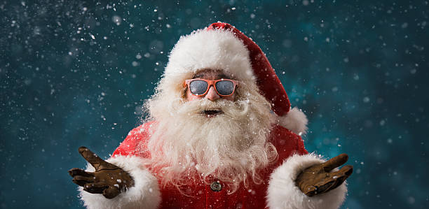 Santa Claus wearing sunglasses dancing outdoors at North Pole stock photo