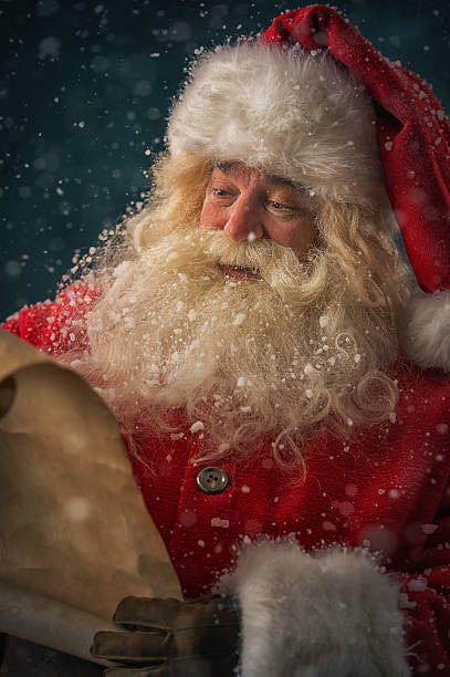 istock Santa Claus reading Christmas letter 491074130