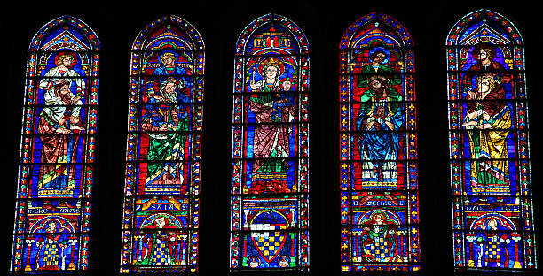 Stained Glass at Chartres Cathedral Stained Glass with Mother Mary, the Four Evangelists and Four Prophets in the Cathedral of Our Lady of Chartres, France chartres cathedral stock pictures, royalty-free photos & images