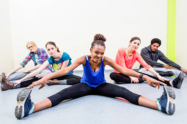 istock Young people stretching legs in gymnastics gym 491083584