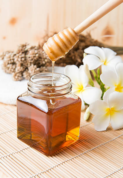 istock honeycomb, honey on wooden background 491085612
