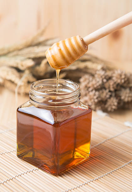 istock honeycomb, honey on wooden background 491086326