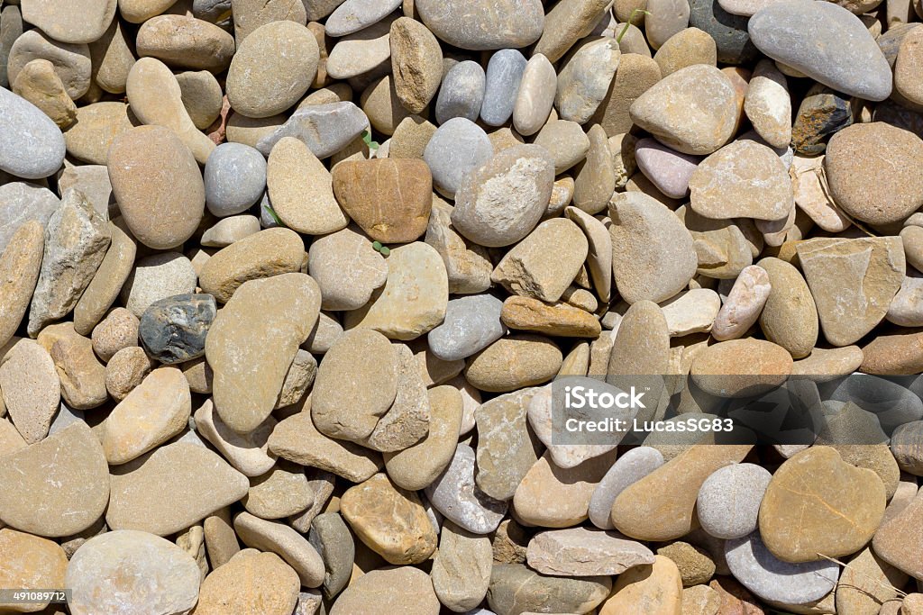 Rounded stones background Background image of brown rounded stones used for decoration in gardens. 2015 Stock Photo