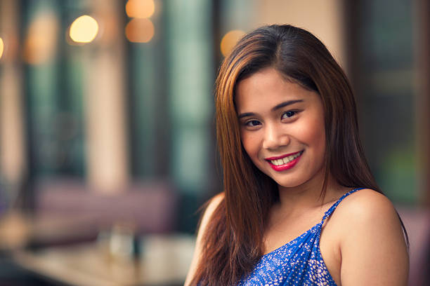 Portrait of young smiling woman outdoors in an urban environment.