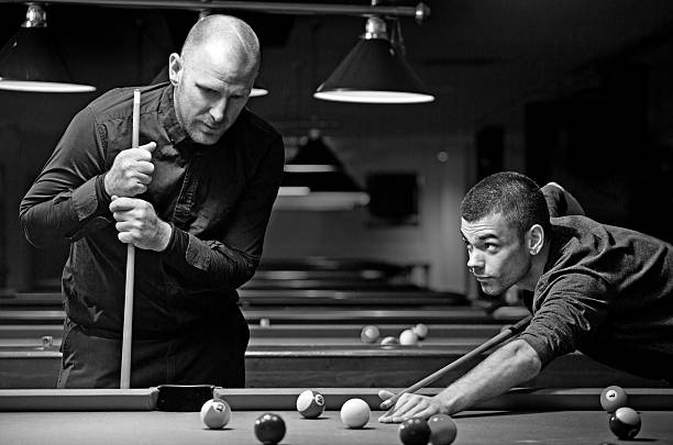 Male friends playing pool