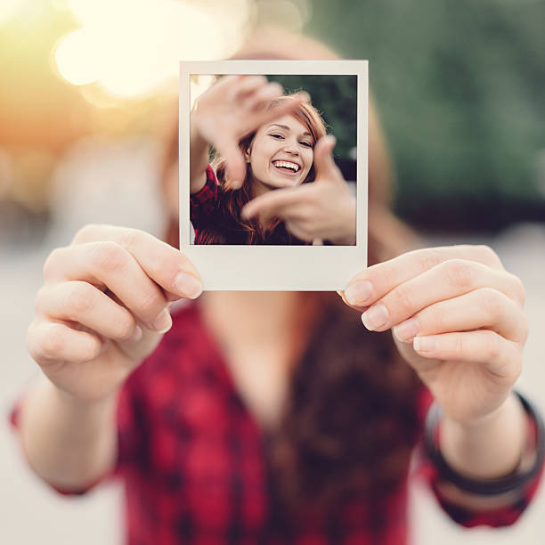 istock Girl holding instant selfie 491117556