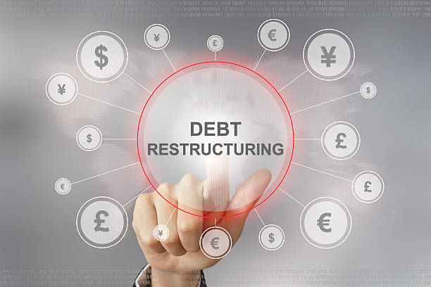 business hand pushing debt restructuring button stock photo