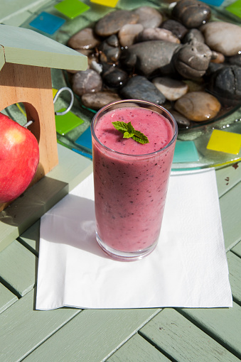 An image of a delicious looking summer fruit smoothie made with bananas, strawberries and raspberries.
