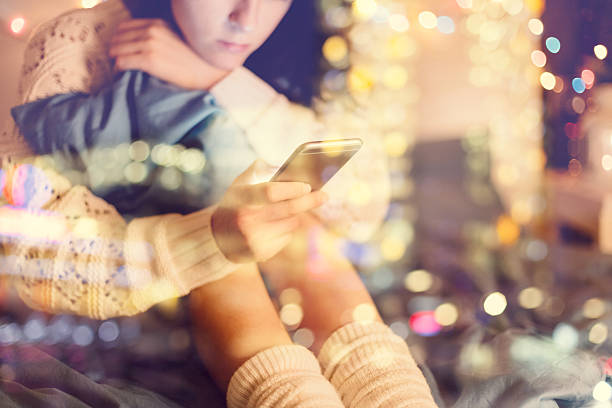 istock Girl in bed using phone 491131518