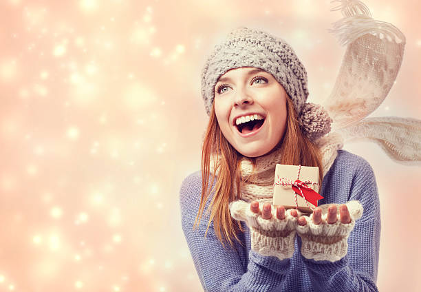 istock Happy young woman holding a small present box 491131688