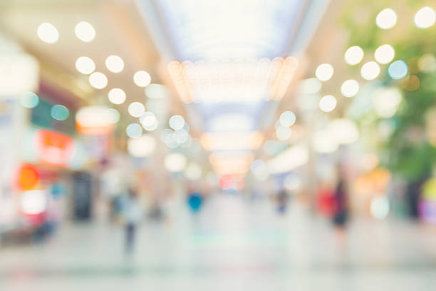 Blurred shopping mall with people walking stock photo