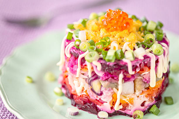 istock Traditional Russian herring salad on green plate 491138118