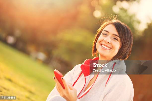 Young Woman Using Mobile Telephone Outside Stock Photo - Download Image Now - 20-29 Years, 2015, Adult