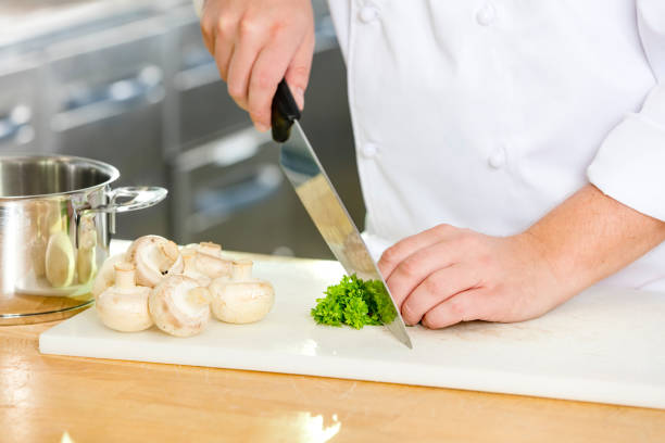 istock Professional chef cutting parley and mushrooms 491138692