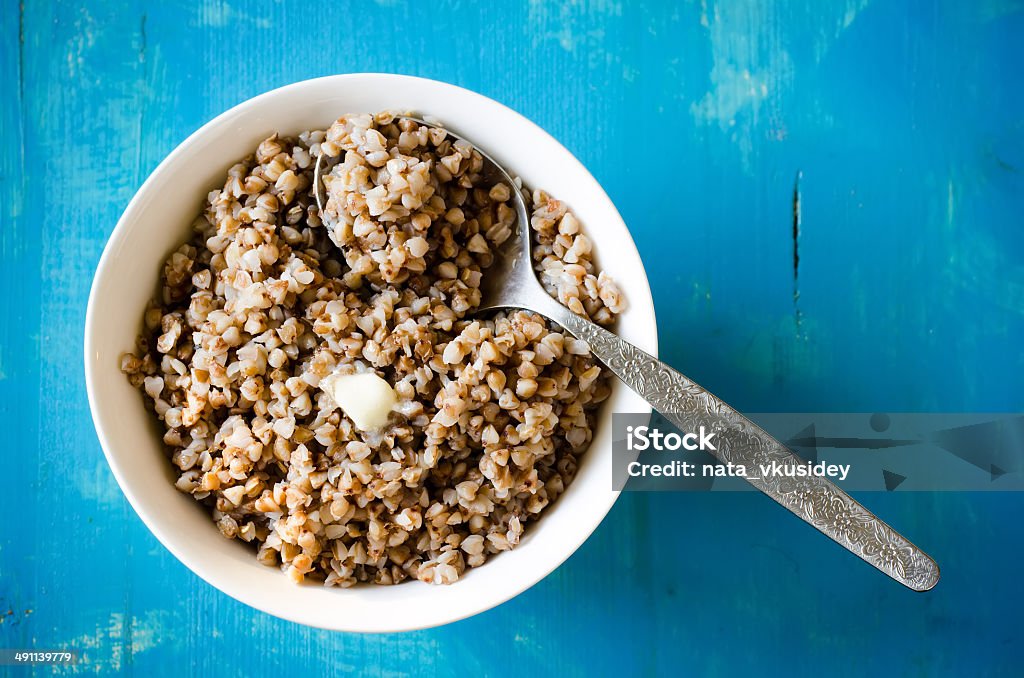 buckwheat porridge buckwheat porridge with butter on a blue background Beige Stock Photo