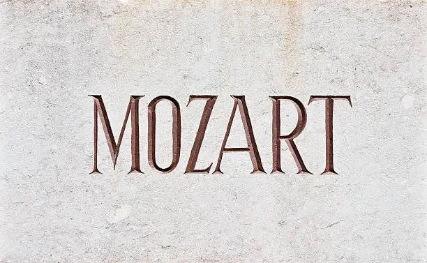 The name Mozart written in capital letters and carved in stone.