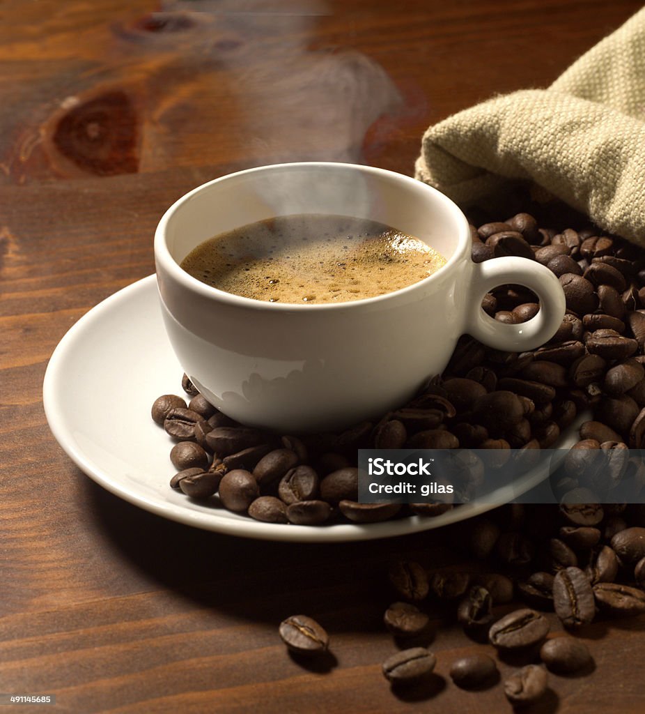 coffee cup coffee cup and grains on wooden table Alcohol - Drink Stock Photo