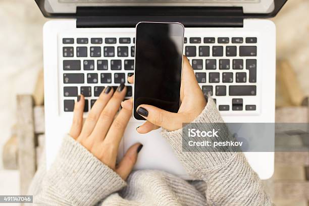 Girl With Cell Phone And Laptop Stock Photo - Download Image Now - 2015, Adult, Business