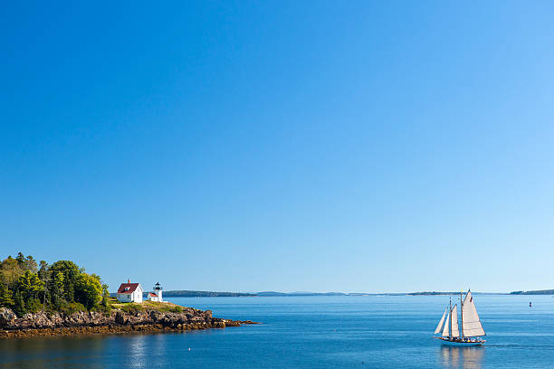 A sailboat and lighthouse near Camden, Maine