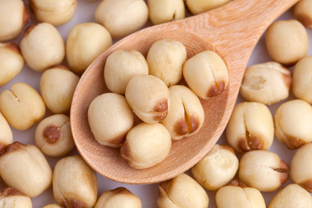 istock close-up lotus seed in wooden spoon 491147882